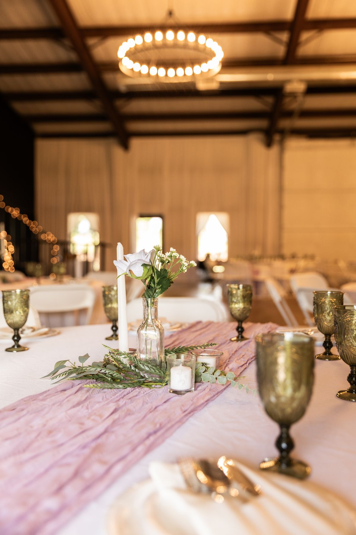 Elegant table settings with candles and blush accents at Heritage Hall